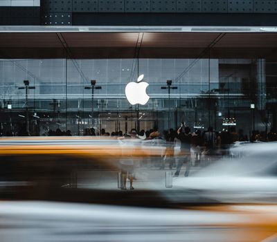 Logo de apple en fachada de entrada mostrando branding expansión empresarial