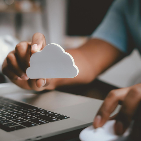 Persona con icono de nube en la mano frente a computador mostrando el valor del branding en startups garantizado con unonu